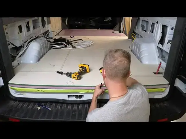 'Video thumbnail for Camper Van Flooring Part 3: Locating spare tire winch point before gluing floor down Ford Transit'