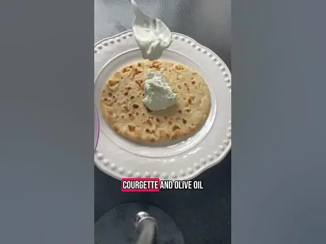 'Video thumbnail for Chicken and tzatziki flatbreads with courgettes, pickled red onions, halloumi and black olives'