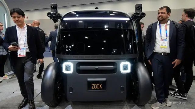 'Video thumbnail for Amazon plans 10,000 Zoox robotaxis per year by 2027'