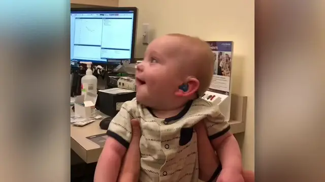 'Video thumbnail for Baby Beams With Joy As Hearing Aid Activated And Hears Parents Speak | Happily TV'