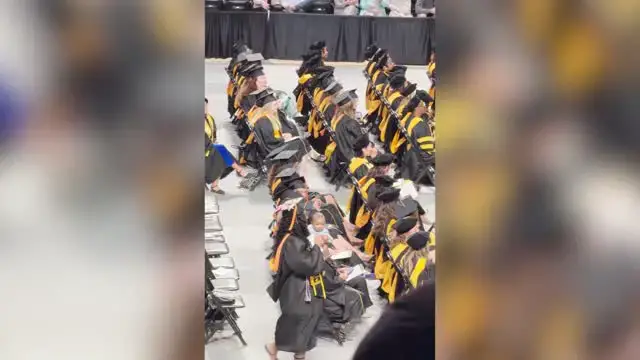 'Video thumbnail for Mom Who Gave Birth During Nursing School Carries Baby Across Graduation Stage'