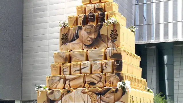 'Video thumbnail for NYC artist mocks Trump-era ICE with migrant tribute made from gold-painted street coolers'