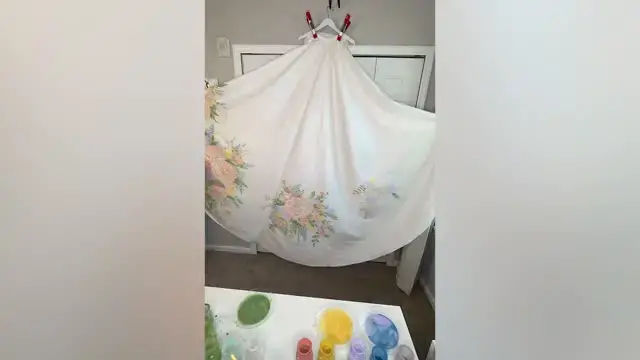 'Video thumbnail for Bride Surprises Friends And Family With Unique Painted Wedding Dress No-One Knew About'