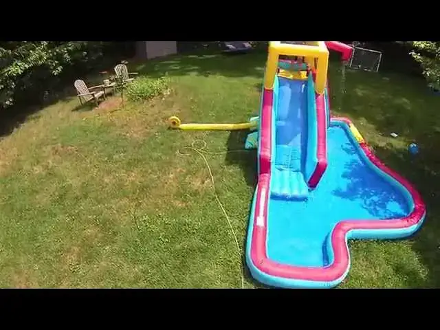 'Video thumbnail for Aerial Drone Footage of Kids Playing on Banzai Slide and Splash Water Slide'